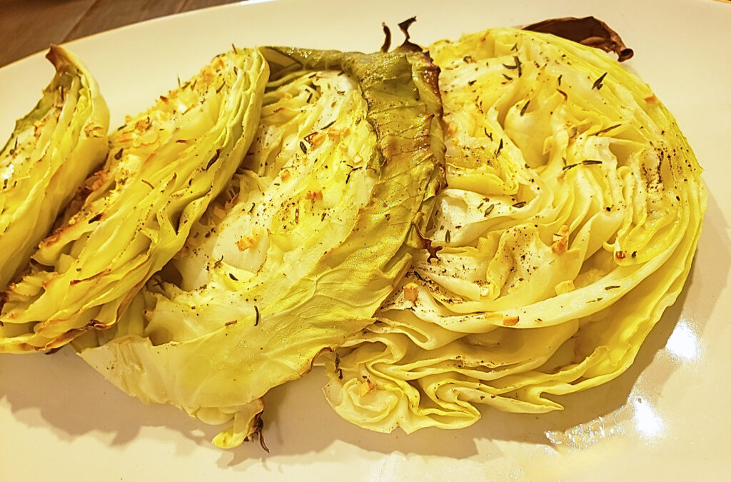 Completed cabbage steak recipe Close-up of cooked cabbage steak recipe on a cream-colored plate