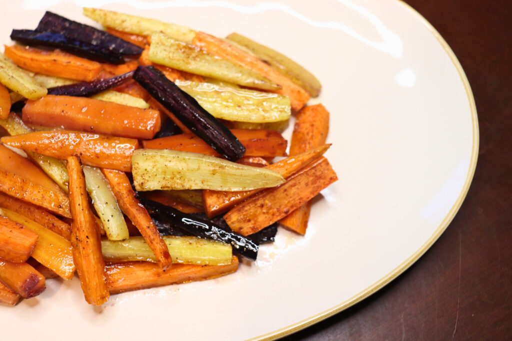 Hot honey roasted carrots on a white plate