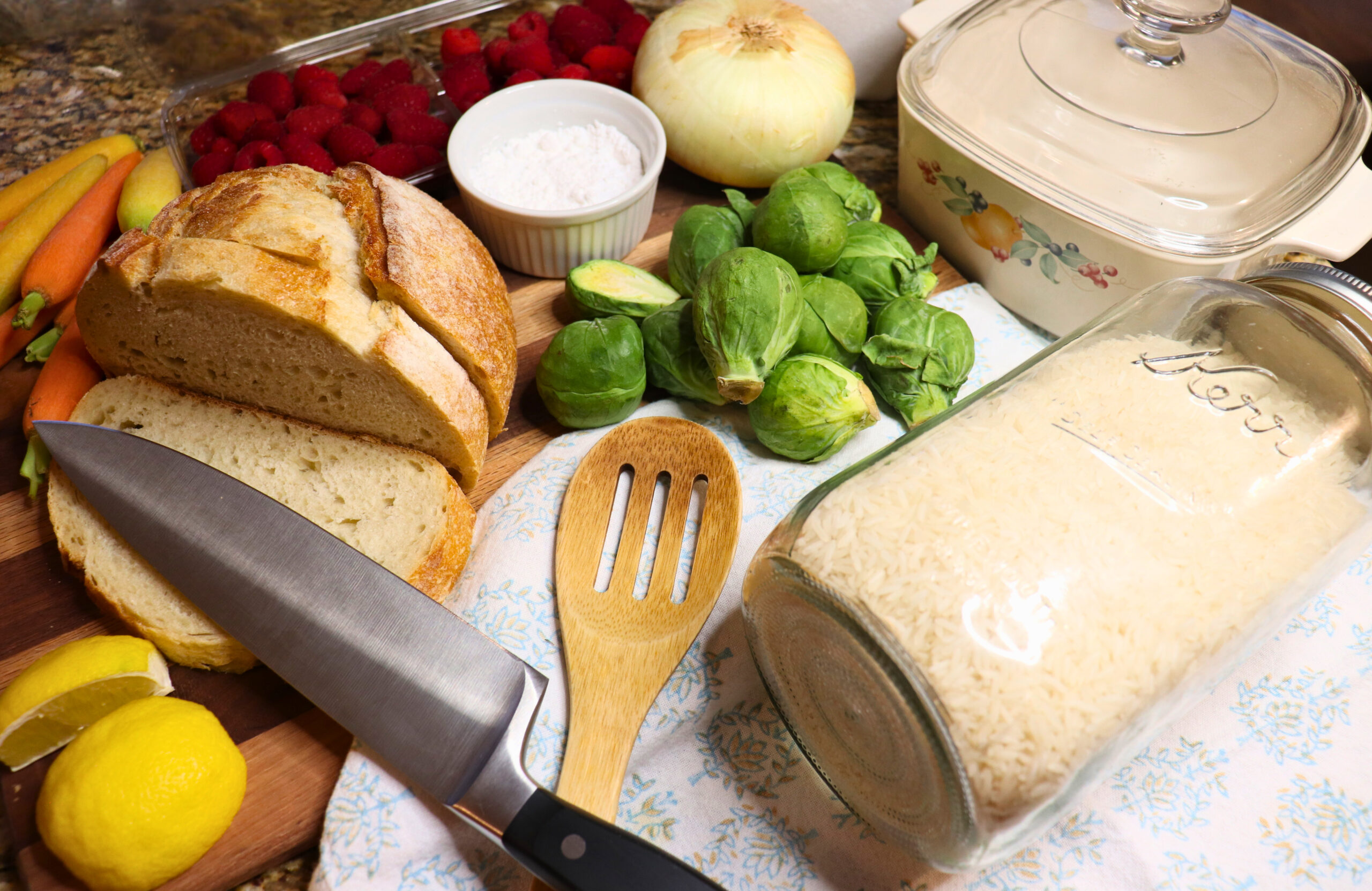 Raw, whole ingredients laid out on a kitchen counter for cooking