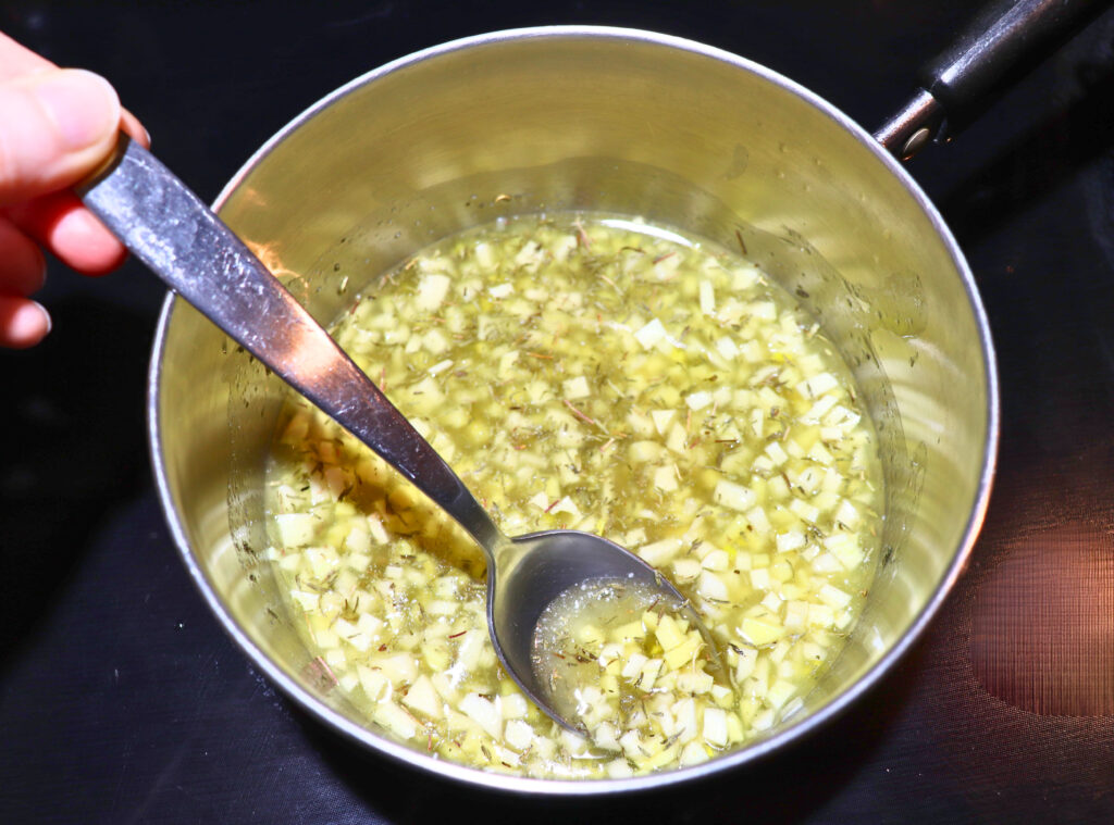 a small pan with garlic, ginger, and butter
