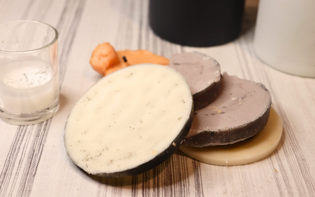 Wax discs next to a candle