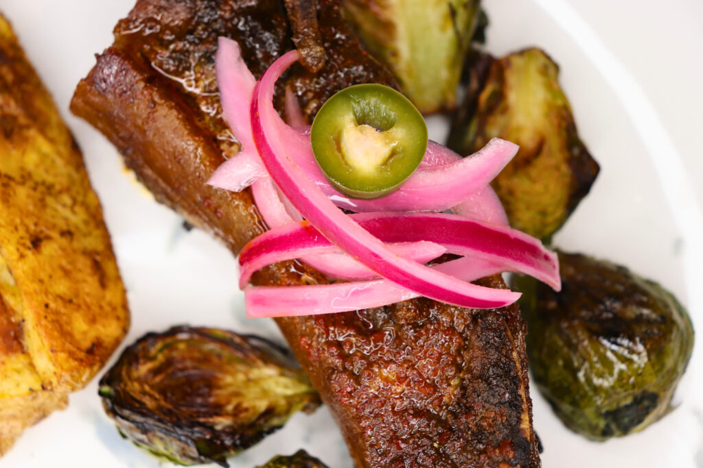 Spicy pickled onions on top of beef ribs