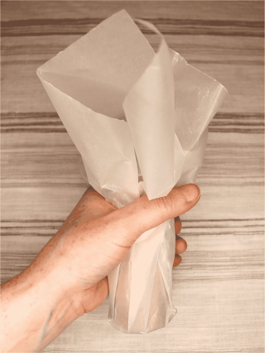 Folded wax paper over a lint fire starter roll