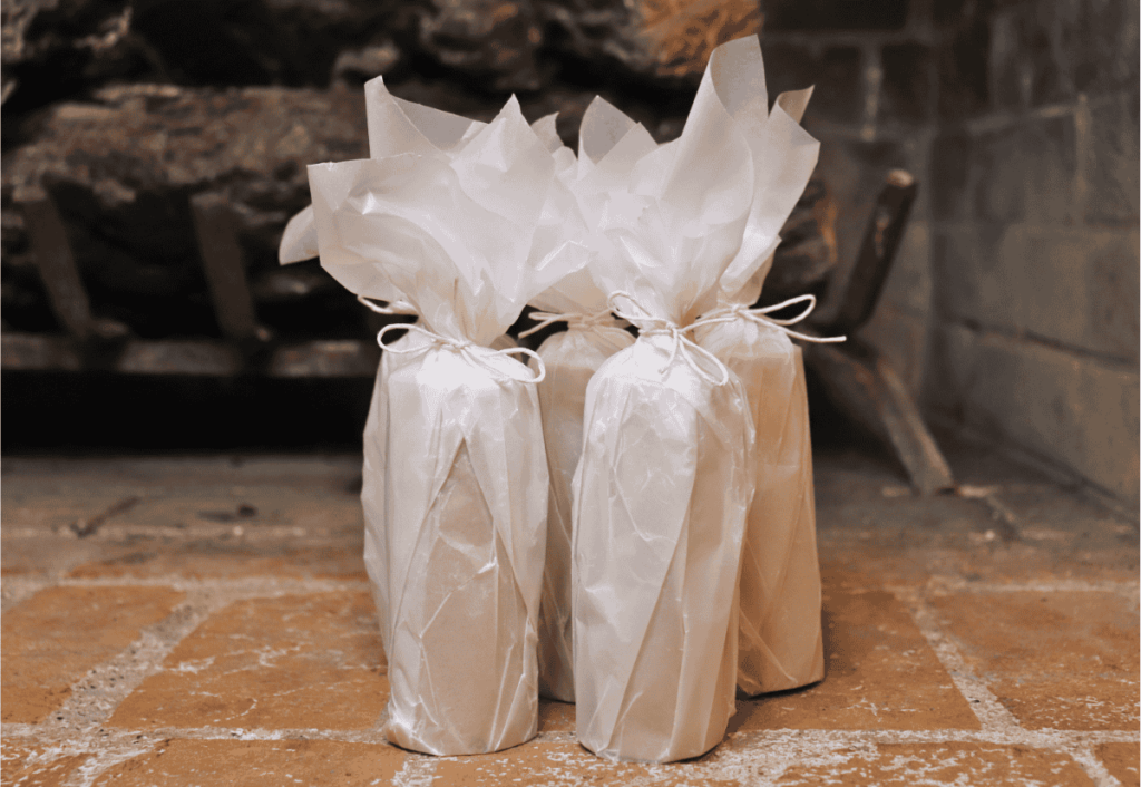 Lint fire starter logs wrapped in wax paper in front of fireplace