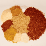Assorted spices on a white plate