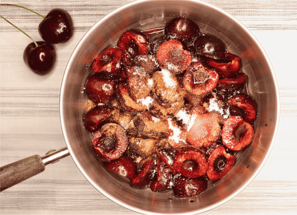 a small pot with cherries, spices, and balsamic vinegar