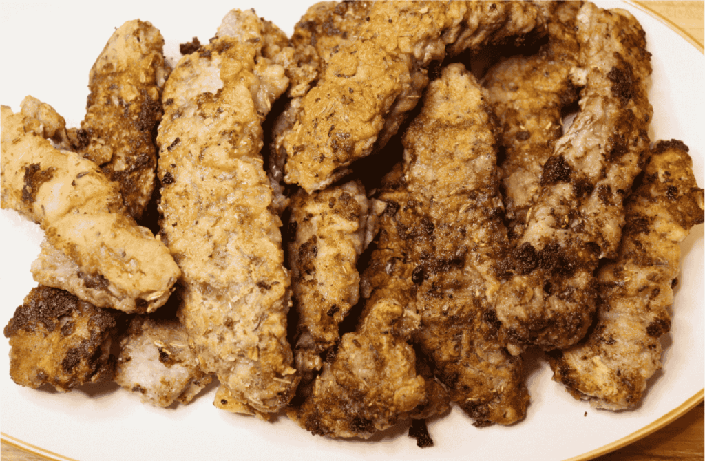 A pile of beef steak fingers on a white plate