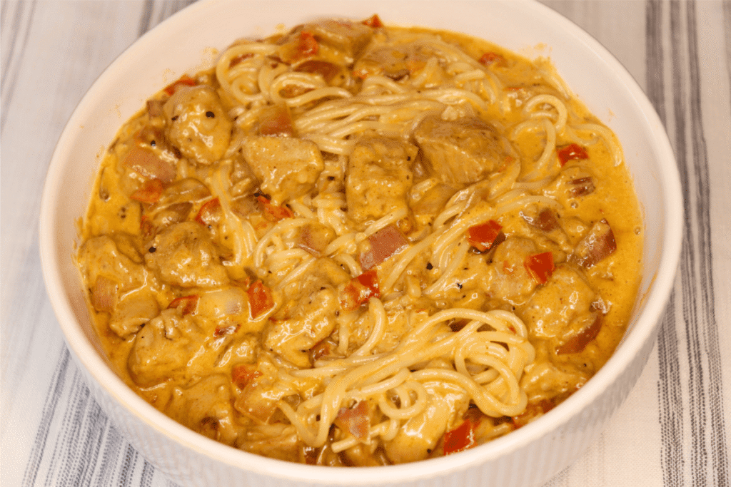 Large white bowl of Cajun chicken Alfredo