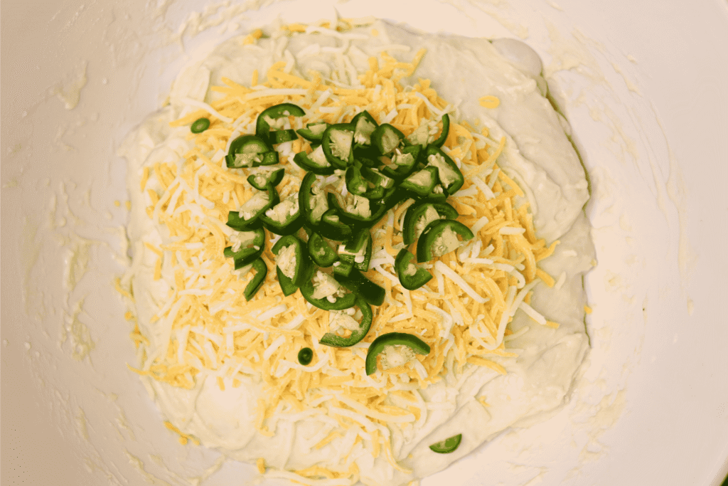 Bread dough with cheddar and diced jalapeños in the middle
