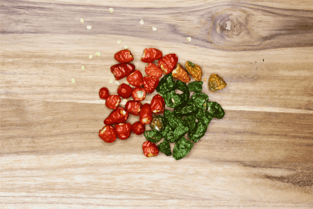 Dried red and green Thai Chilis on wood