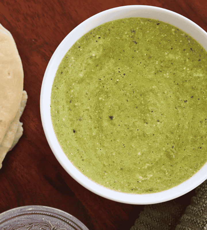 Bowl of poblano crema sauce by some torillas