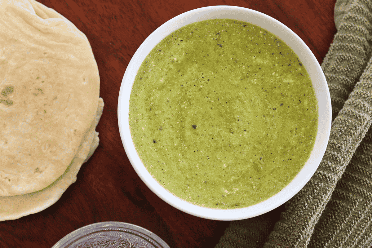 Shows the final product of this recipe: a smooth and creamy green poblano crema sauce