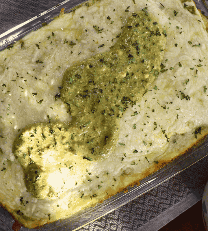 Chicken enchilada casserole next to poblano crema