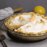 lemon meringue pie with a slice cut out