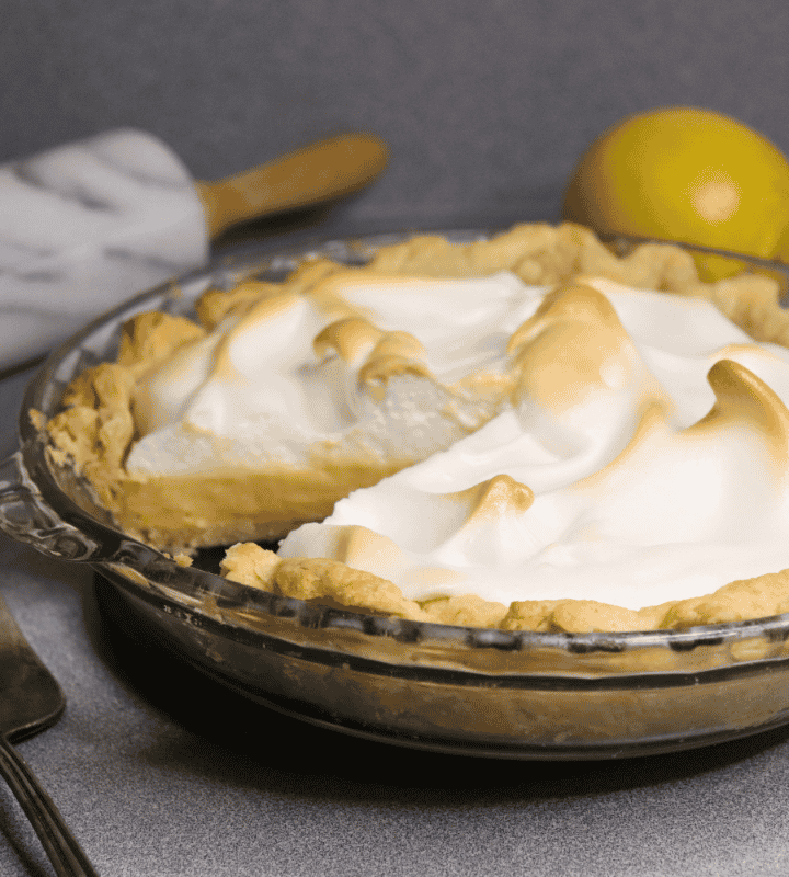 lemon meringue pie with a slice cut out
