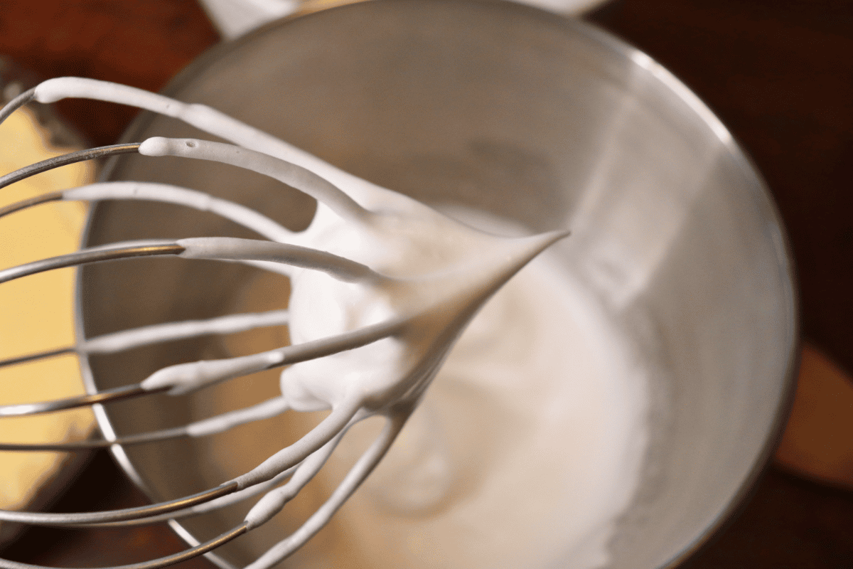 Stiff peak of an egg white meringue on a whisk