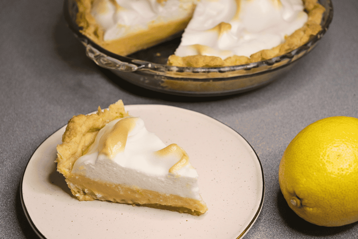 Slice of lemon meringue pie on a small plate
