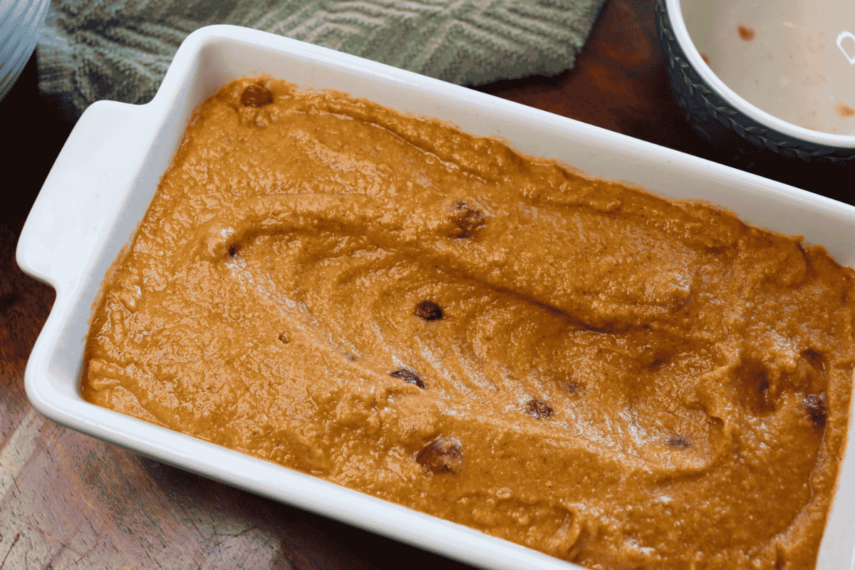 Pumpkin cranberry batter in a ceramic loaf pan