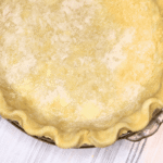 Raw shaped pie crust on a white cloth