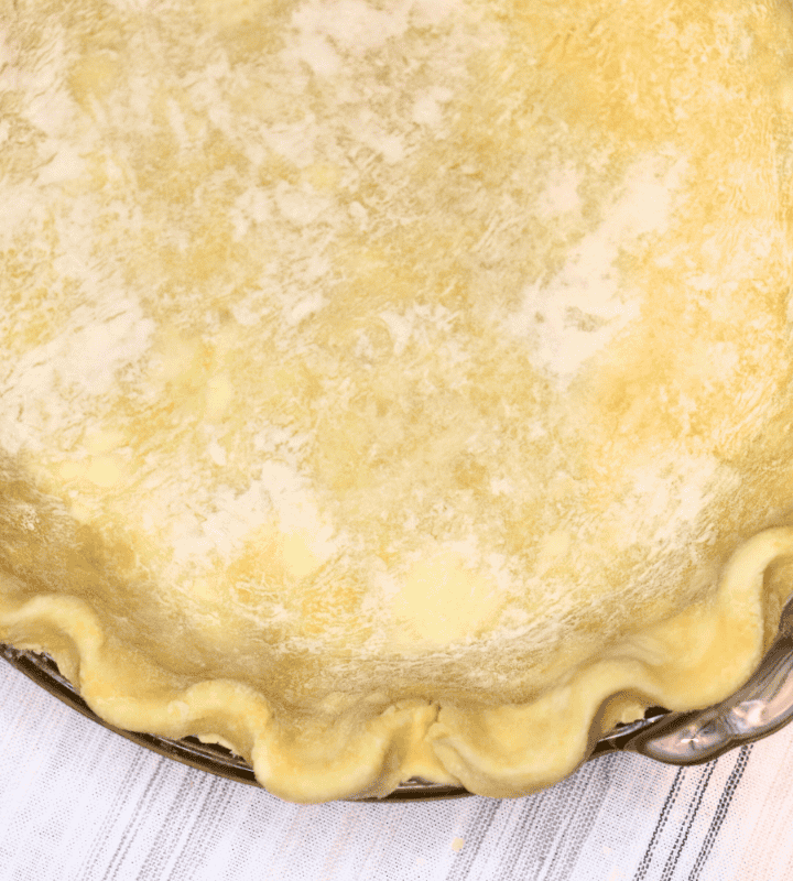 Raw shaped pie crust on a white cloth
